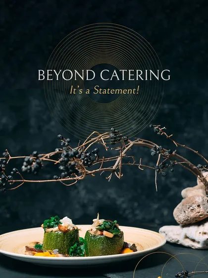 Beyond catering, it's a statement. Stuffed zucchini is artfully plated with a vibrant sauce and crisp greens, garnished with a sprig of berries to create a dish that is as beautiful as it is delicious.