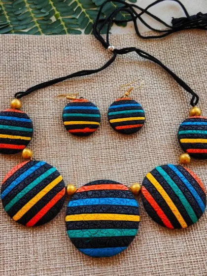 Here is another colorway for the striped circular necklace, with shades of blue, teal, and orange. It's a versatile piece that pairs well with both Indian and Western outfits.