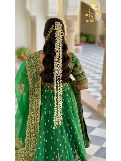 For a beautiful Mehendi look, I created this open half-tie hairstyle with soft waves. The cascading gajra and elegant kaan chain earrings add a touch of traditional grace.