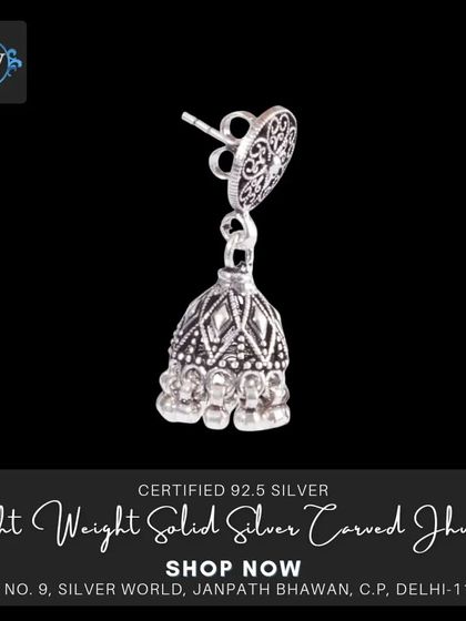 A side view of our solid silver carved jhumki, showing the secure push-back closure and the fine detailing from every angle.