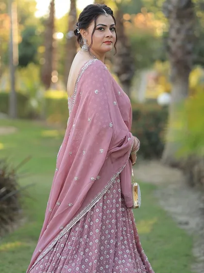 A side profile showing the elegant updo and the soft, glowing makeup.