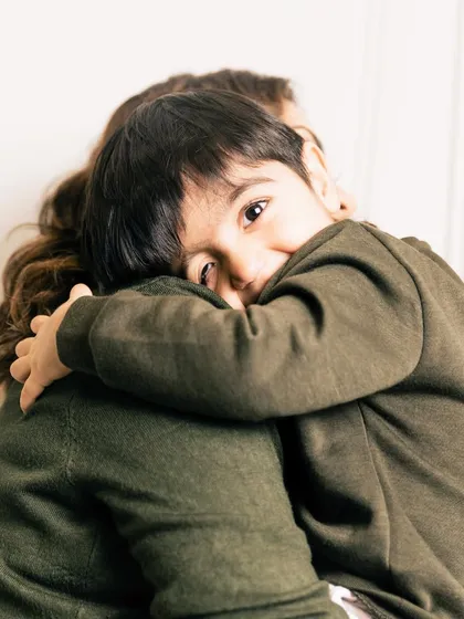 A son’s first love and a mother’s forever valentine. This sweet hug, with his little eyes peeking over her shoulder, is a moment of quiet connection that speaks volumes.