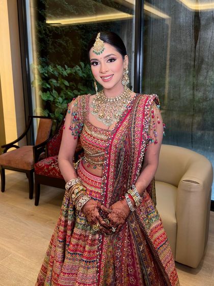 A full view of the client celebrating Teej, her traditional braid with gota, shells, and gajra perfectly matching the festive occasion.