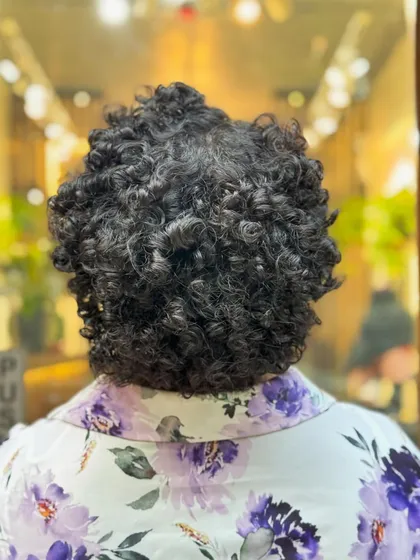 Embracing the beauty of a TWA (Teeny Weeny Afro). This big chop reveals the gorgeous texture of coily hair and is a healthy, stylish way to start a natural hair journey.