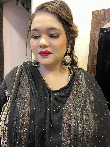 A beautiful no-filter party look. The skin is glowing, and the bold red lip adds a perfect pop of color. This is a classic look that is always in style.