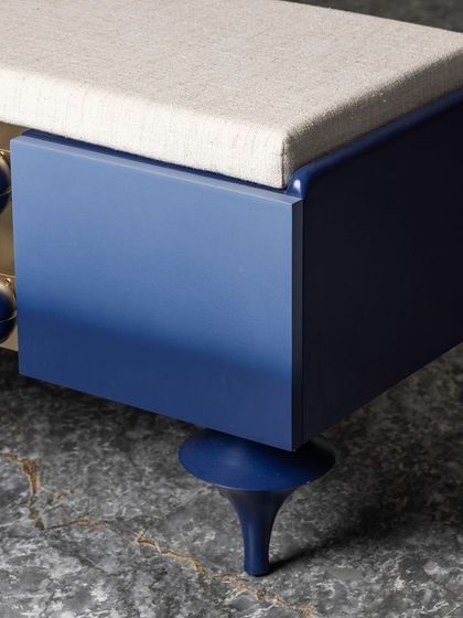 A close-up of the uniquely shaped, hand-turned legs on the ombre bench. Each leg is a small sculpture in itself, showcasing our commitment to detailed craftsmanship even in the most unexpected places.