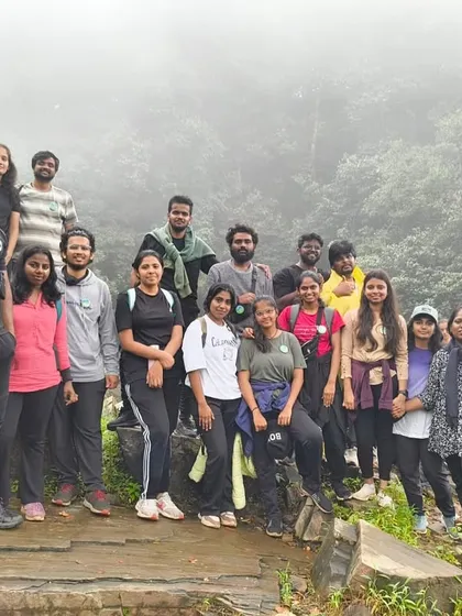 The group posing on a rocky outcrop during the Bandaje trek, with the misty valley behind us.