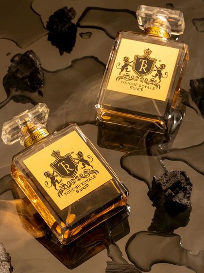 For this luxury perfume, I created a dark and sensual mood by placing the bottles on a reflective, wet surface with pieces of charcoal. This concept was designed to evoke a smoky, intense, and mysterious fragrance.