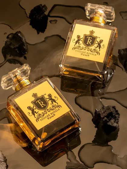 For this luxury perfume, I created a dark and sensual mood by placing the bottles on a reflective, wet surface with pieces of charcoal. This concept was designed to evoke a smoky, intense, and mysterious fragrance.