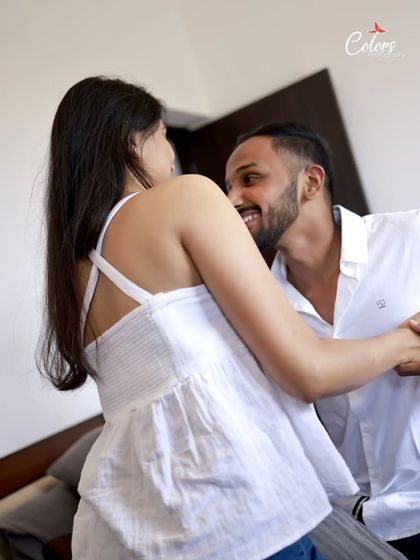 A candid moment of dance and laughter in a simple home setting.