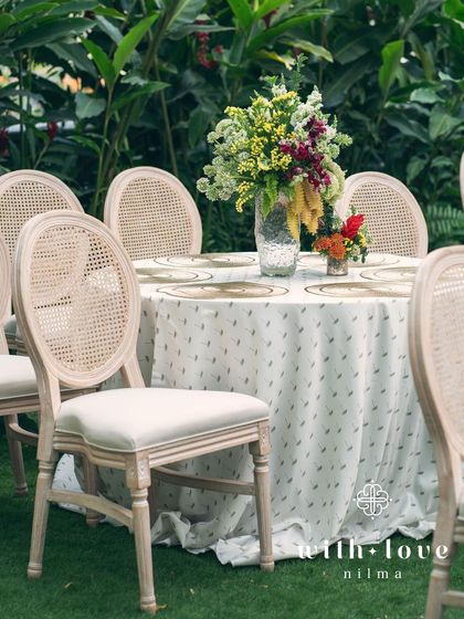 A tablescape from the 'Garden of Gaia' event, with a beautiful floral centerpiece and custom linens.