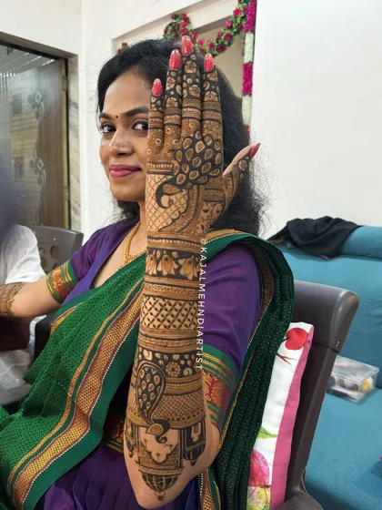 The beautiful bride showing off her peacock-themed henna.