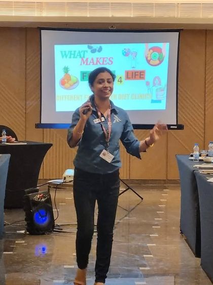Presenting my approach to holistic nutrition at a corporate event. I emphasize that my clinic, Foods4Life, focuses on sustainable lifestyle changes rather than just temporary diet plans.