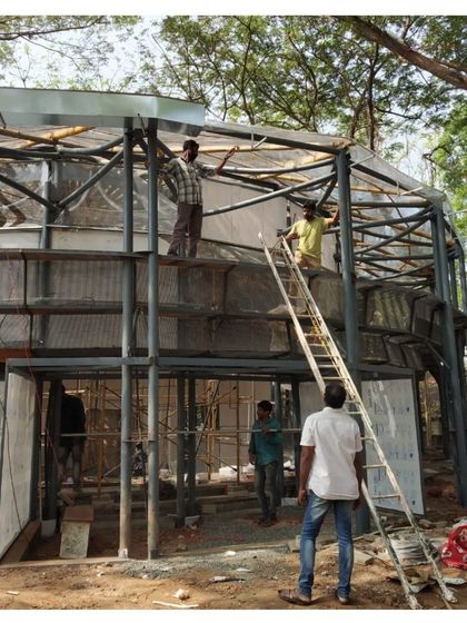 The construction of the Koodaaram Pavilion in progress. The image shows the assembly of the steel and bamboo framework, a process completed in just two months.