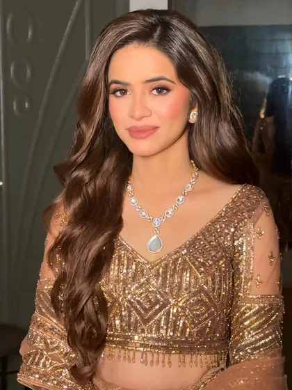 Nude makeup and soft curls come together for a look that's pure perfection. This is a classic soft glam style that is versatile enough for any wedding event.