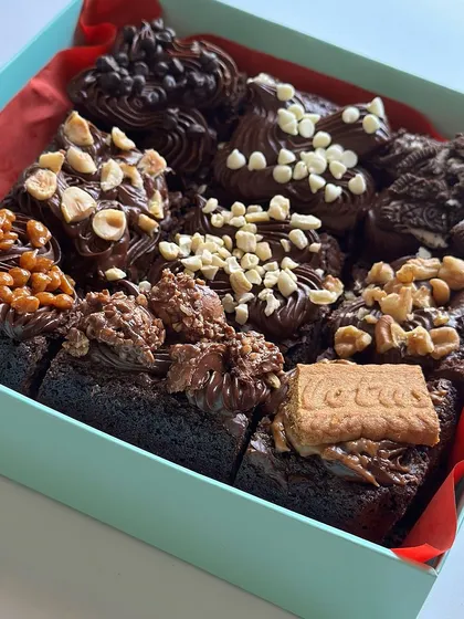 An assorted box of our fudgy, decadent, and eggless chocolate brownies. This box, created for Father's Day, features nine different toppings including Lotus Biscoff, Oreo, roasted hazelnuts, and various chocolate chips.