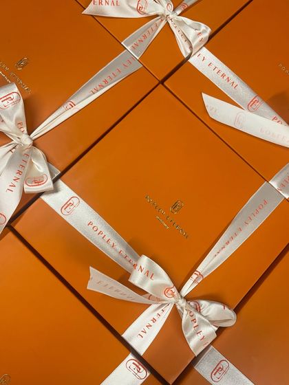 A top-down view of the beautifully branded boxes for Popley Eternal. When you're sending hundreds of gifts, consistent and high-quality presentation is key. We ensure every single box that leaves our bakery meets that standard.