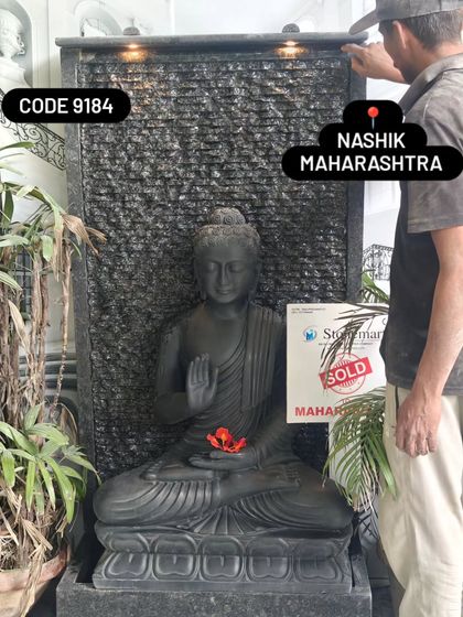 Another view of the black marble Buddha fountain with its integrated lighting. The warm lights create a beautiful contrast with the cool, dark stone.