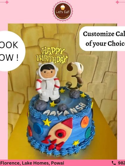 An out-of-this-world astronaut cake for a 3rd birthday. The cake is decorated with planets, stars, and a rocket ship, with a little fondant astronaut on top ready for an adventure.