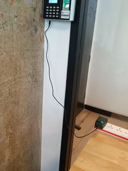 Another angle of the Wi-Fi enabled biometric attendance machine, showing its placement in the office environment.