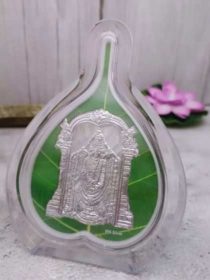 This 999 pure silver Tirupati Balaji idol is presented in a unique pan-leaf shaped acrylic frame, making it a modern and auspicious gift.