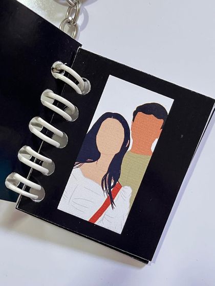 A faceless portrait inspired by a scene from a favorite show or movie, inside a keychain.