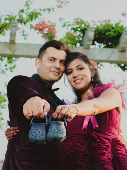 A fun and classic announcement pose. The couple holds up tiny shoes, a perfect prop to pair with our beautiful maternity gowns.