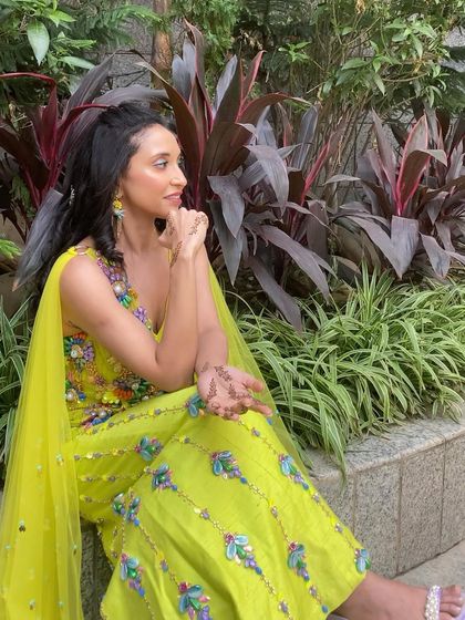 A side profile of the bride, highlighting her beautiful smile and the fresh, glowing makeup that is perfect for daytime celebrations.