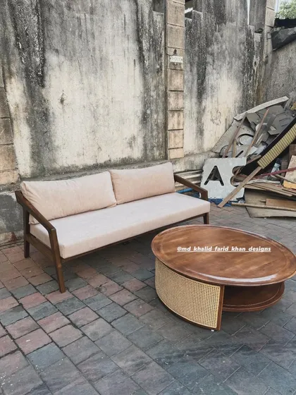 The living room set shown against a rustic wall.
