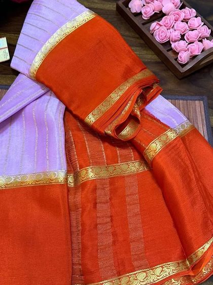A beautiful wrinkle crepe Mysore silk saree in lavender and orange. These sarees are Silk Mark certified and have a unique texture that drapes beautifully.