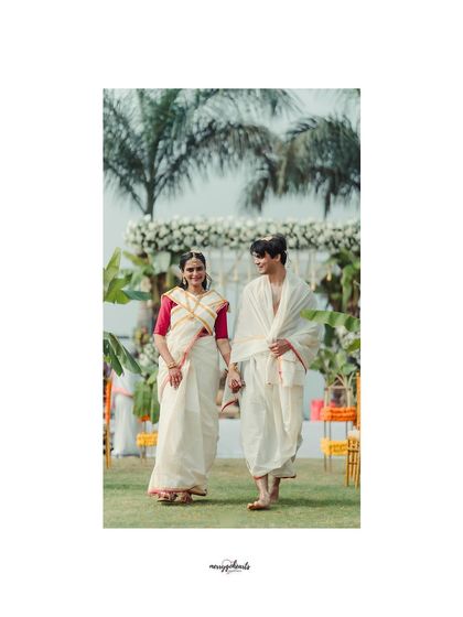 A beautiful portrait of a couple walking hand-in-hand after their ceremony. The simple, elegant decor allows their happiness to be the main focus.