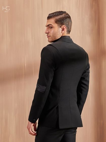 A back view of the textured cocktail jacket, highlighting the clean lines and the subtle band detailing on the sleeves.