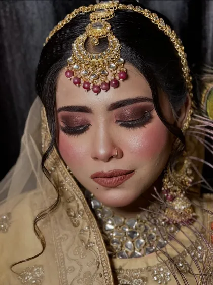 Another angle of the dark, smoky eye look. The model's expression is soft and serene, contrasting beautifully with the dramatic makeup.