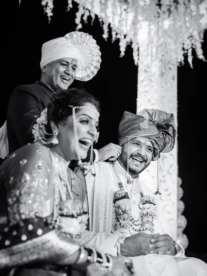 Pure, unadulterated laughter during a wedding ceremony. This candid black and white shot freezes a moment of joy between the couple and their family, making it timeless.
