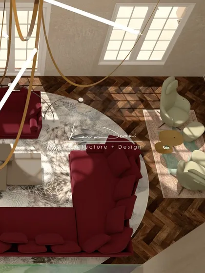 A top-down view of the statement living room, showing the arrangement of the bold red sofa on a circular rug. This perspective highlights the herringbone pattern of the wood floor and the generous scale of the space.