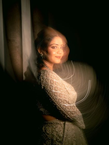 An artistic bridal portrait using a slow shutter speed to create a dreamy, motion-blur effect.