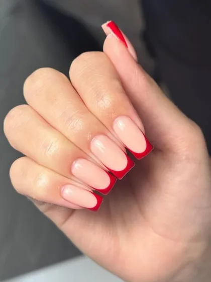 A classic red French manicure on square-shaped nails, a bold and timeless choice.