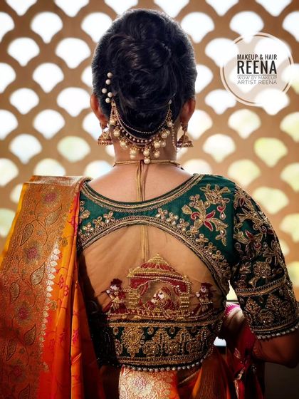 A closer look at the stunning details of Aditi's bridal blouse, featuring a 'doli' design. Her elegant bun is adorned with pearl hair accessories.