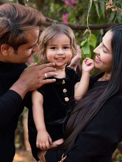 A beautiful family moment captured outdoors. The love and adoration in their eyes as they look at their daughter is what family photography is all about. Outdoor sessions offer a relaxed and natural setting.