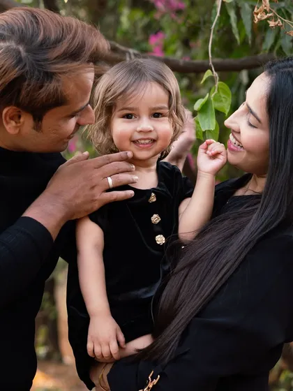 A beautiful family moment captured outdoors. The love and adoration in their eyes as they look at their daughter is what family photography is all about. Outdoor sessions offer a relaxed and natural setting.