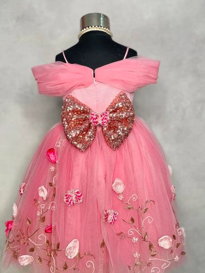 A closer look at the details of our "Princess Diaries" gown. The sequined bow on the back adds a touch of sparkle to the beautifully embroidered floral tulle skirt.