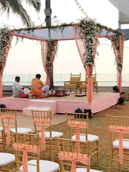 Another view of the simple and elegant peach-themed mandap. This setup is perfect for couples who want the beauty of the ocean to be the main star of their wedding ceremony.