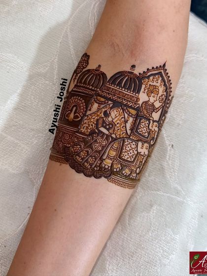 A close-up of the armband showing the groom's grand entry on a royal elephant.