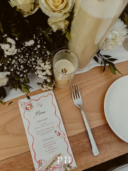A custom menu card for the sit-down dinner, adding a personal and thoughtful touch to the tablescape.