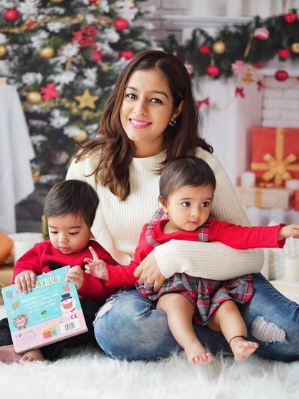 A mother with her two little ones during a Christmas mini session. It's a joy to capture the holiday magic for growing families year after year.