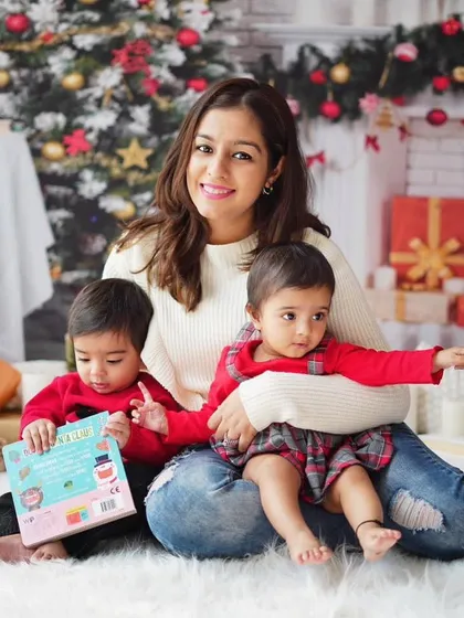 A mother with her two little ones, reading a Christmas story. These sessions are perfect for capturing the magic of the holidays with your children.