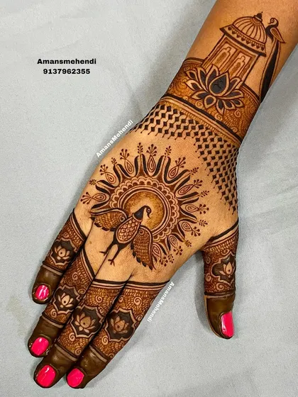 A striking back-hand design with a sun-like mandala featuring a peacock at its center. The wrist cuff shows a palace dome and lotus.