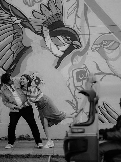 A playful dance in front of a vibrant street art mural in Delhi. We love using the city's own art as a dynamic background for your love story.