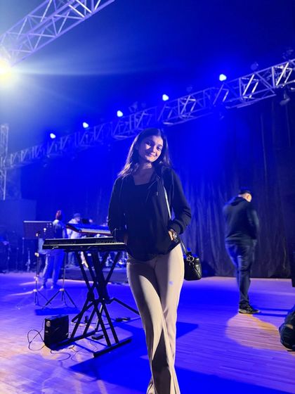 A quick photo on stage before the show starts. The blue lights and the keyboard setup hint at the musical night ahead.