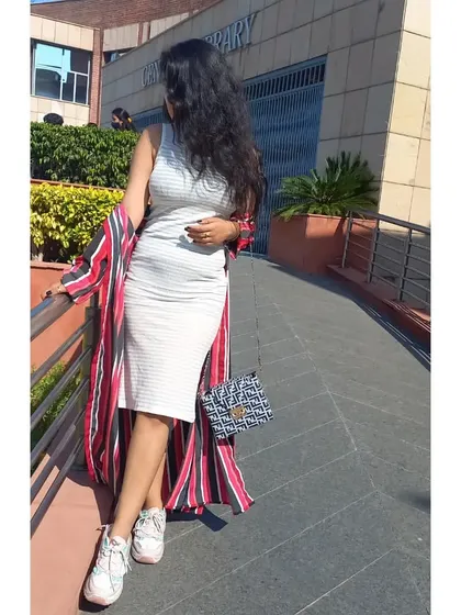 A comfortable and stylish layering look for college. I wore a longline red and black striped shrug over a simple white bodycon dress, finished with chunky white sneakers and a patterned bag.